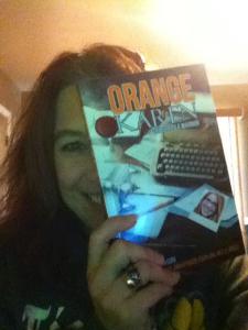 Reader Brandi shows us her copy of Orange Karen (and in the background an orange glow. Coincidence?).
